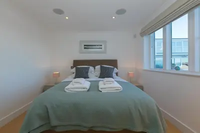 a bedroom with a bed with towels on it at Ithaca in St Ives