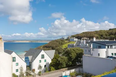 a view of a town with a body of water at Ithaca in St Ives