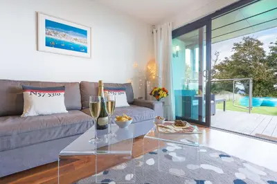 a living room with a couch and a glass table at Coast in St Ives