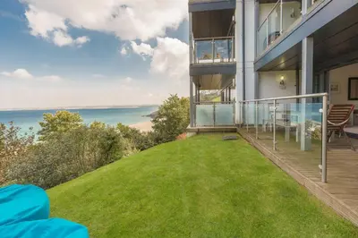a balcony of a house with a view of the ocean at Coast in St Ives