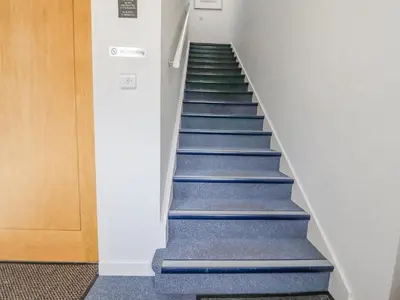 a stairway with blue and green stairs in a building at Ocean Blue in Carbis Bay