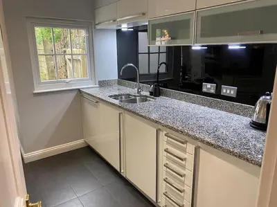 a kitchen with a sink and a counter top at Fuchsia Cottage in Flushing