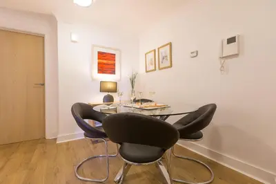a dining room with a table and four chairs at Serendipity in St Ives