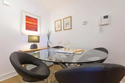 a dining room with a glass table and two chairs at Serendipity in St Ives