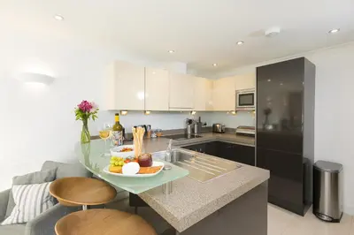 a kitchen with a table with a bowl of fruit on it at Tides in St Ives