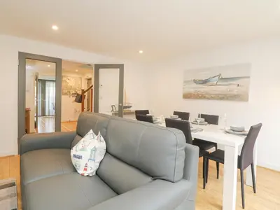 a living room with a couch and a table at Bluebell Retreat in Lostwithiel