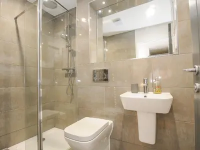 a bathroom with a toilet and a sink and a shower at Bluebell Retreat in Lostwithiel