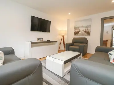 a living room with two couches and a tv at Bluebell Retreat in Lostwithiel