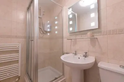 a bathroom with a sink and a shower and a toilet at Sowena in Carbis Bay