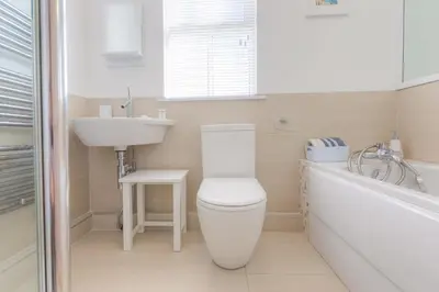 a bathroom with a toilet and a sink and a tub at Sea Dream in St Ives