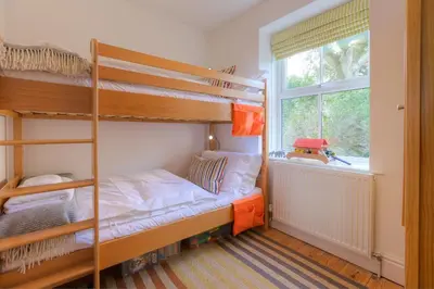 a bedroom with two bunk beds and a window at Sea Dream in St Ives