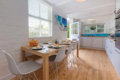 a kitchen with a table and chairs in a kitchen at Sea Dream in St Ives