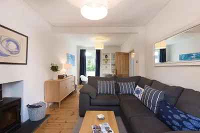 a living room with a couch and a table at Sea Dream in St Ives