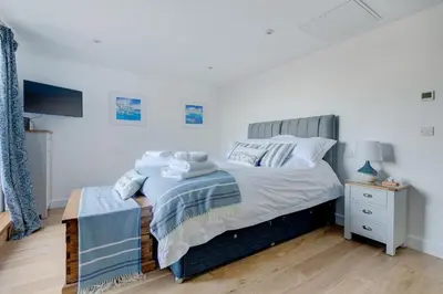 a bedroom with a bed and a night stand at Sea Vista in Carbis Bay