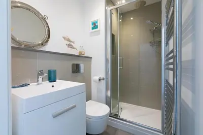 a bathroom with a toilet and a sink and a shower at Sea Vista in Carbis Bay