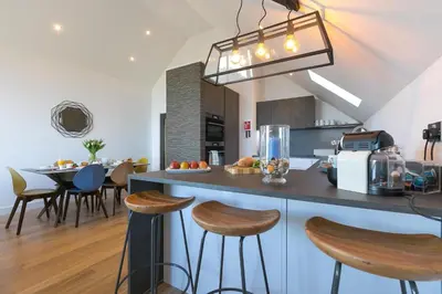 a kitchen with a counter and some stools in a room at Sea Vista in Carbis Bay