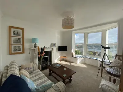 a living room with a couch and a fireplace at Frobisher Apartments in Falmouth