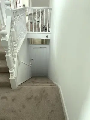 a stairway with white stairs and a white stair case at Frobisher Apartments in Falmouth