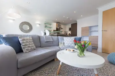 a living room with a couch and a table at The Sanctuary in St Ives