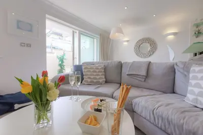 a living room with a couch and a table at The Sanctuary in St Ives