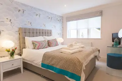 a bedroom with a bed with towels on it at The Sanctuary in St Ives