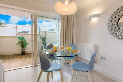 a dining room with a table and chairs and a window at The Sanctuary in St Ives