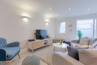 a living room with a couch and a tv at The Sanctuary in St Ives