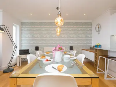 a kitchen and dining room with a table and chairs at Shamal in Carbis Bay
