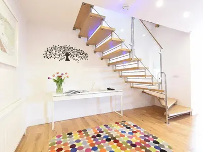 a white room with a staircase and a table at Shamal in Carbis Bay