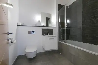 a bathroom with a toilet and a sink and a shower at The Oyster in St Ives