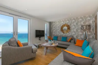 a living room with a view of the ocean at The Oyster in St Ives
