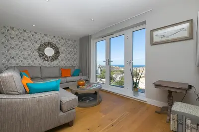 a living room with a couch and a table at The Pearl in St Ives