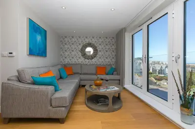 a living room with a couch and a table at The Pearl in St Ives