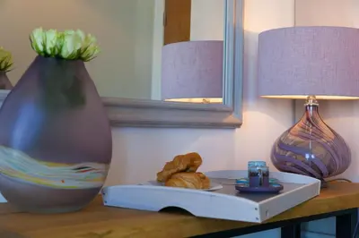 a table with a plate of food and a vase at The Pearl in St Ives