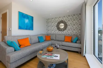 a living room with a couch and a table at The Pearl in St Ives