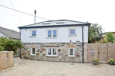 a stone house with a solarium on top of it at Charming Cottage, Wi-Fi, Parking, Pets Accepted in Newquay