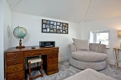 a living room with a desk and a chair at Charming Cottage, Wi-Fi, Parking, Pets Accepted in Newquay