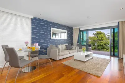 a living room with a couch and a table at Waters Edge in St Ives