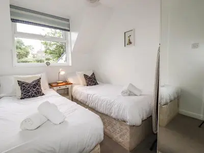 a bedroom with two twin beds and a window at Padstowgetaways in Padstow