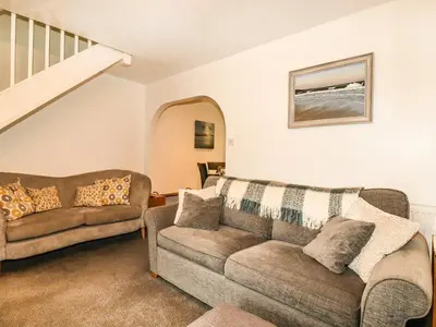 a living room with a couch and a chair at Padstowgetaways in Padstow