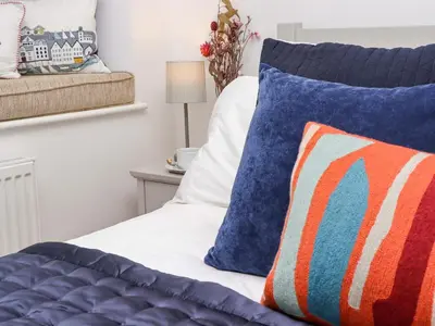 a bedroom with a bed with two pillows on it at The View in St Ives