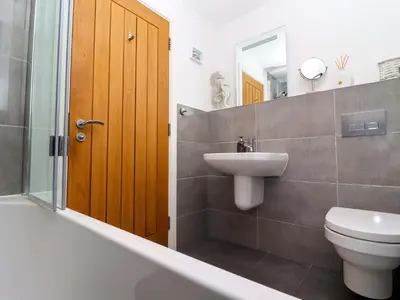 a bathroom with a toilet and a sink and a shower at The View in St Ives