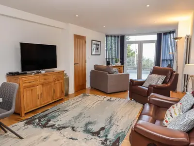a living room with a flat screen tv and furniture at The View in St Ives
