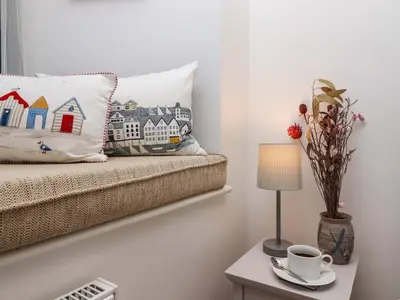 a room with a couch and a table with a lamp at The View in St Ives