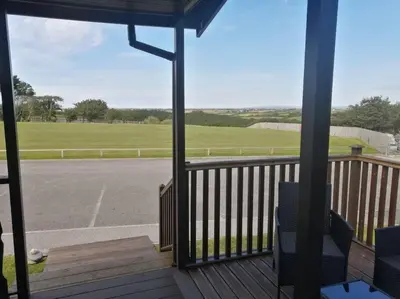 a porch with a view of a parking lot at Marios Lodge in Padstow