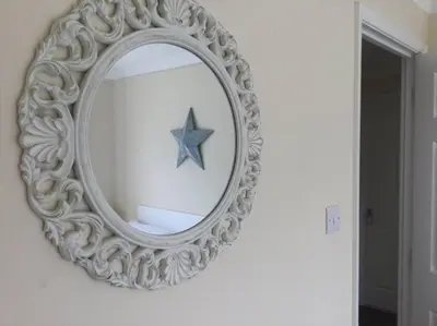 a mirror on a wall with a star in it at Marios Lodge in Padstow
