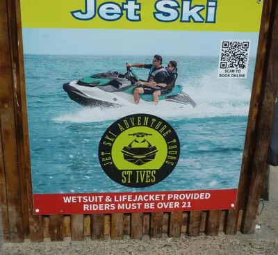 a sign with a man on a jet ski in the water at Grey Mullet Guesthouse in St Ives