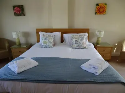 a bedroom with a bed with two towels on it at Bay Retreat - Widemouth Bay Bude Cornwall in Bude