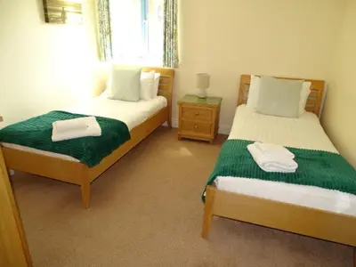 a bedroom with two beds with towels on them at Bay Retreat - Widemouth Bay Bude Cornwall in Bude