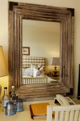 a mirror on top of a desk in a bedroom at Driftwood B&B in Porthscatho